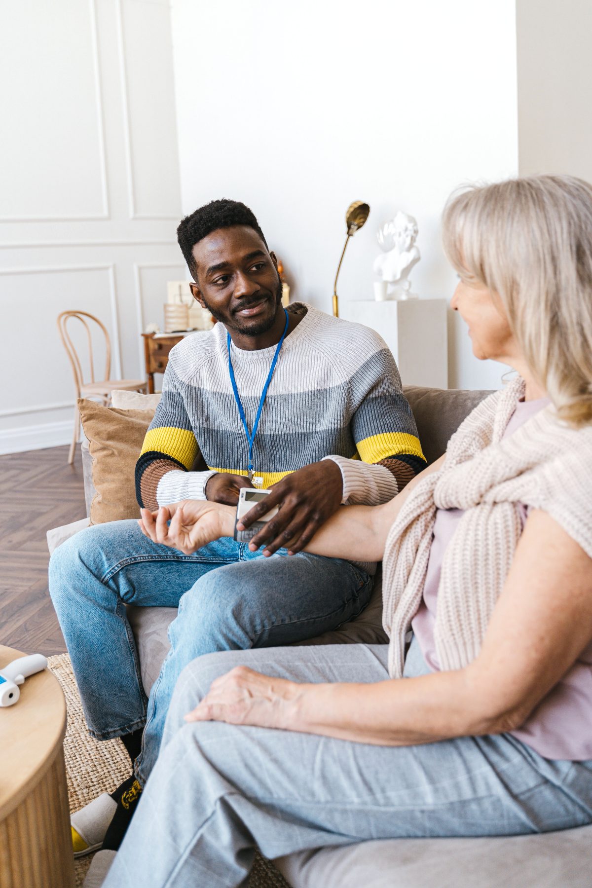 A care worker supporting a client during a home care visit